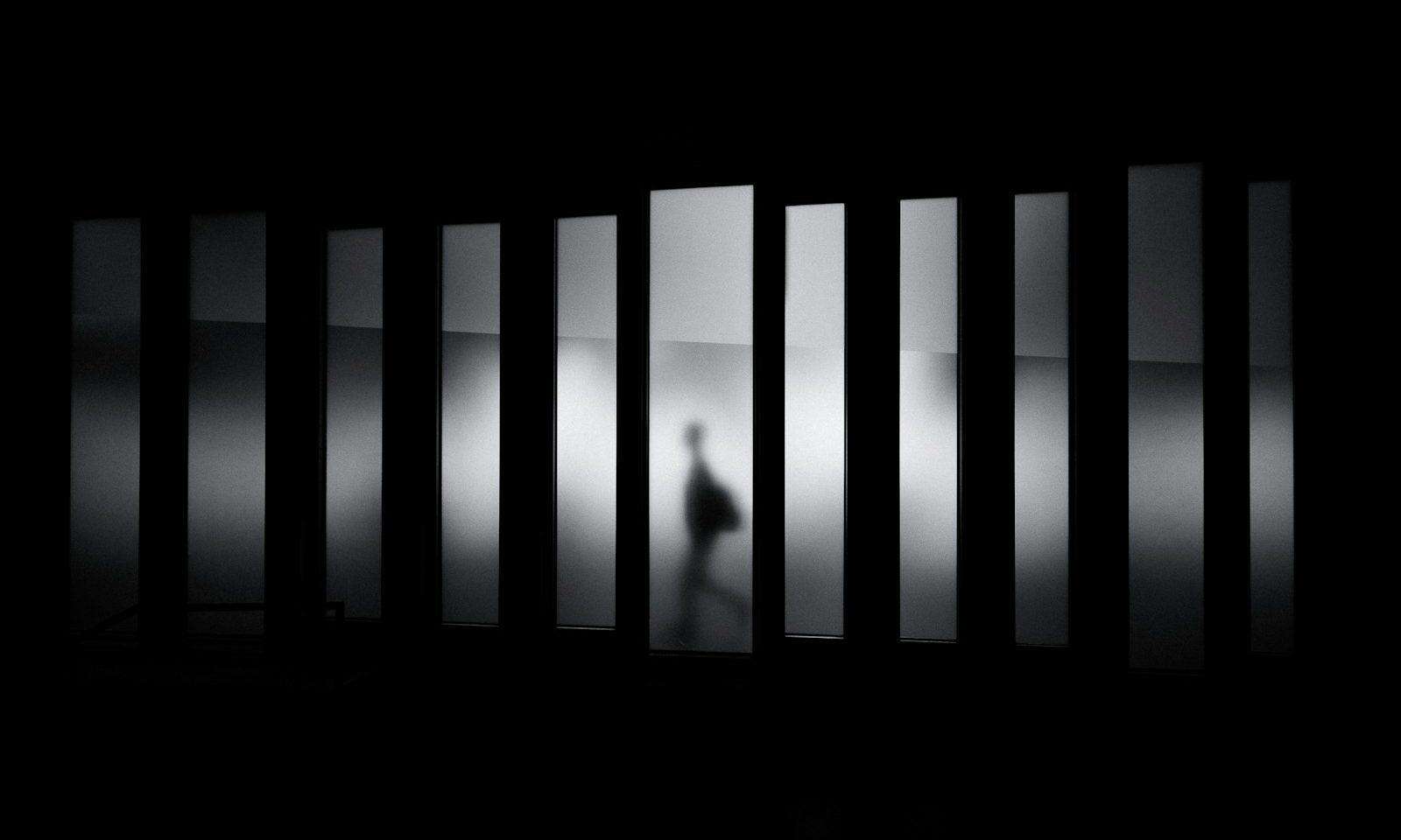 grayscale photo of person running in panel paintings